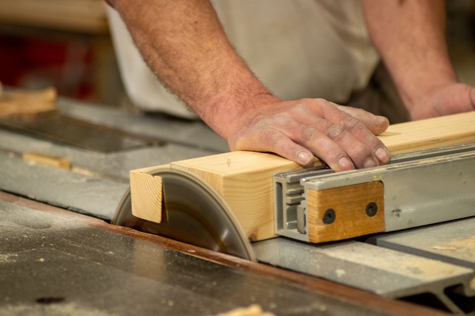 Carpenter building custom cabinets in a workshop